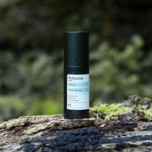 Ladda upp bild till gallerivisning, Product shot of ReGlow – Face Serum standing on a moss covered tree trunk

